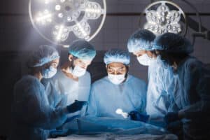 Surgical team performing complex wound reconstruction procedure in operating room