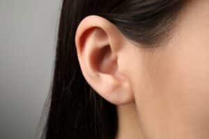 Side profile of a woman showing the shape and position of her ear.