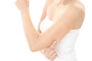 Woman checking her upper arm