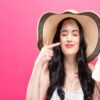 Skin Cancer Awareness Month: Why Daily SPF Use Matters Woman large sunhat applying spf sunscreen to prevent skin cancer
