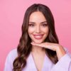 Smiling woman gently framing her beautifully reshaped chin with her hand
