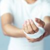 Man holding up injured hand that's been medically wrapped
