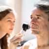 Dermatologist examining man's face for skin cancer
